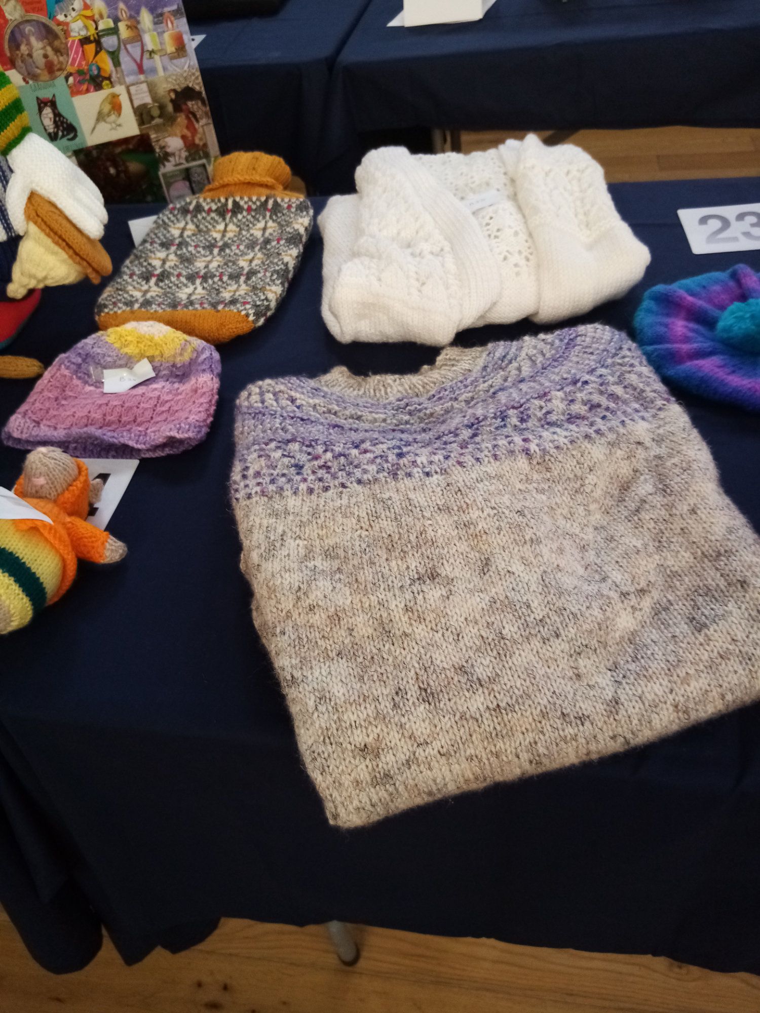 A table with a bunch of knitted items on it