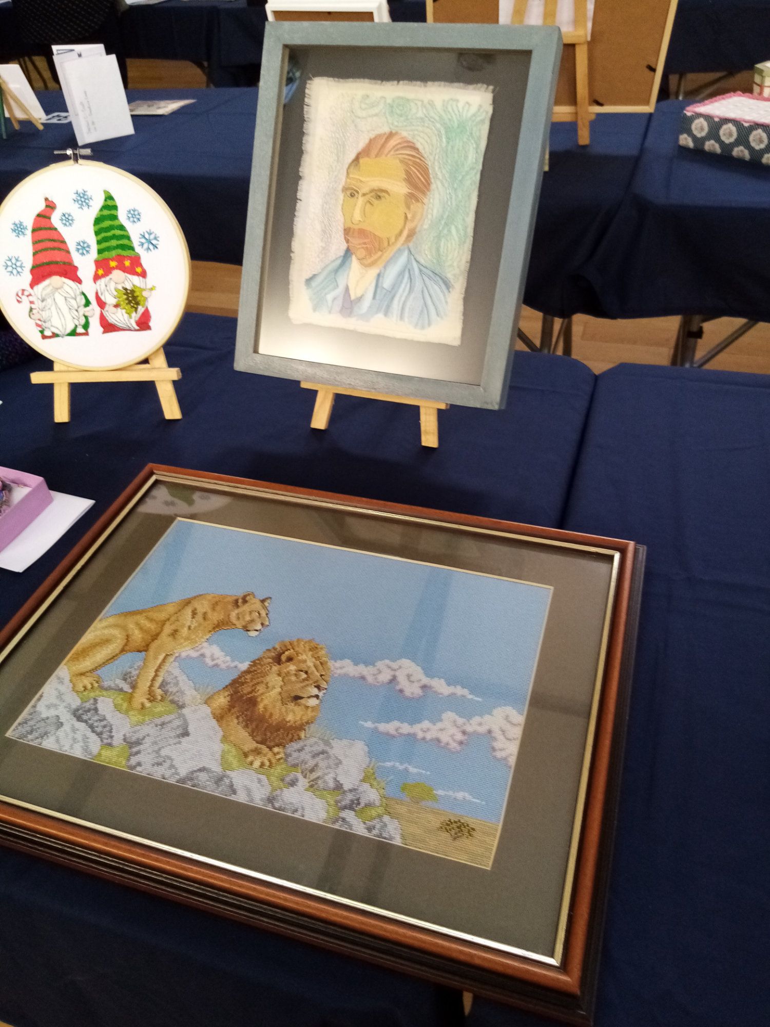 A framed painting of a lion is on a table