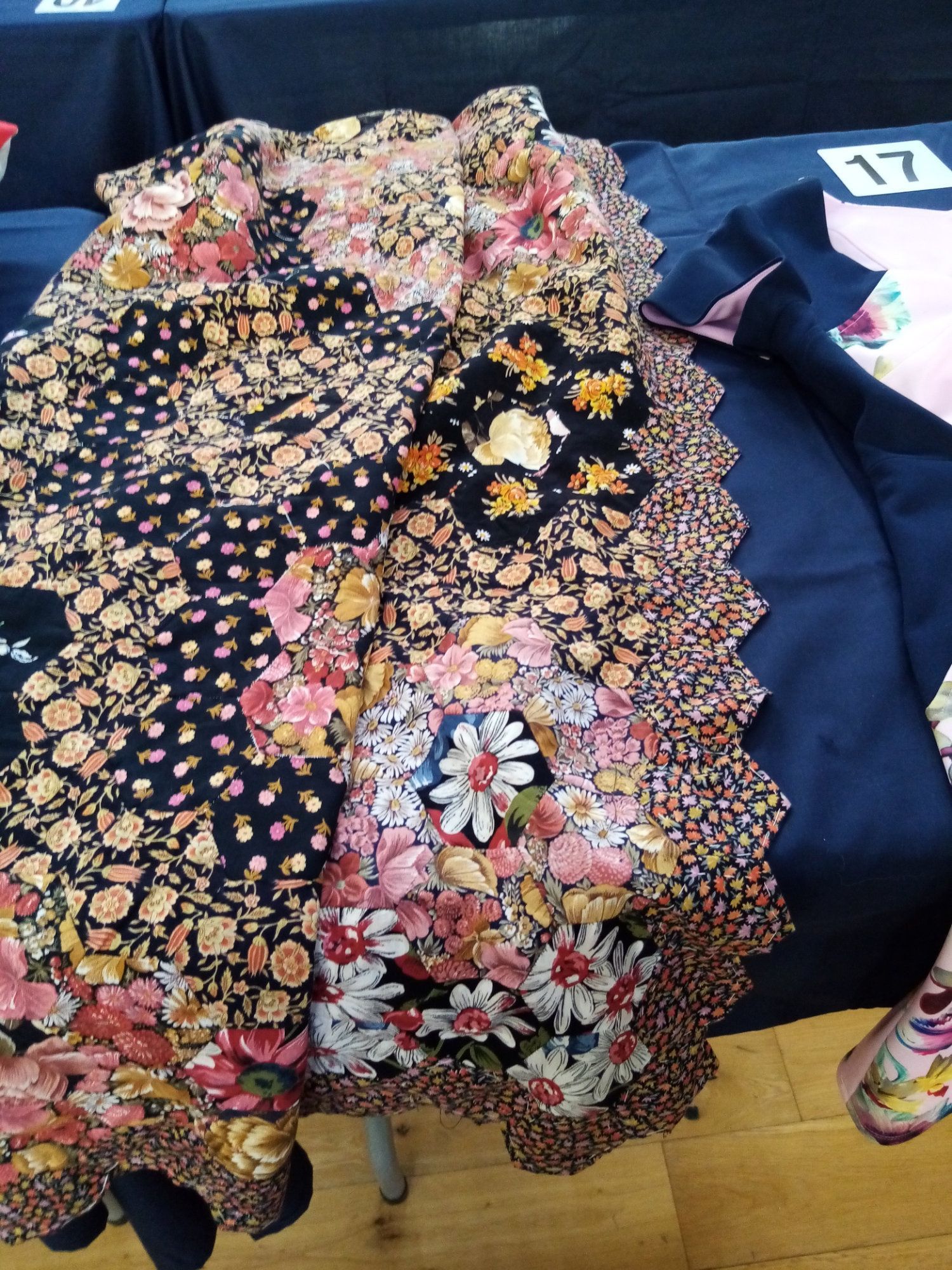 A quilt with flowers on it is on a table