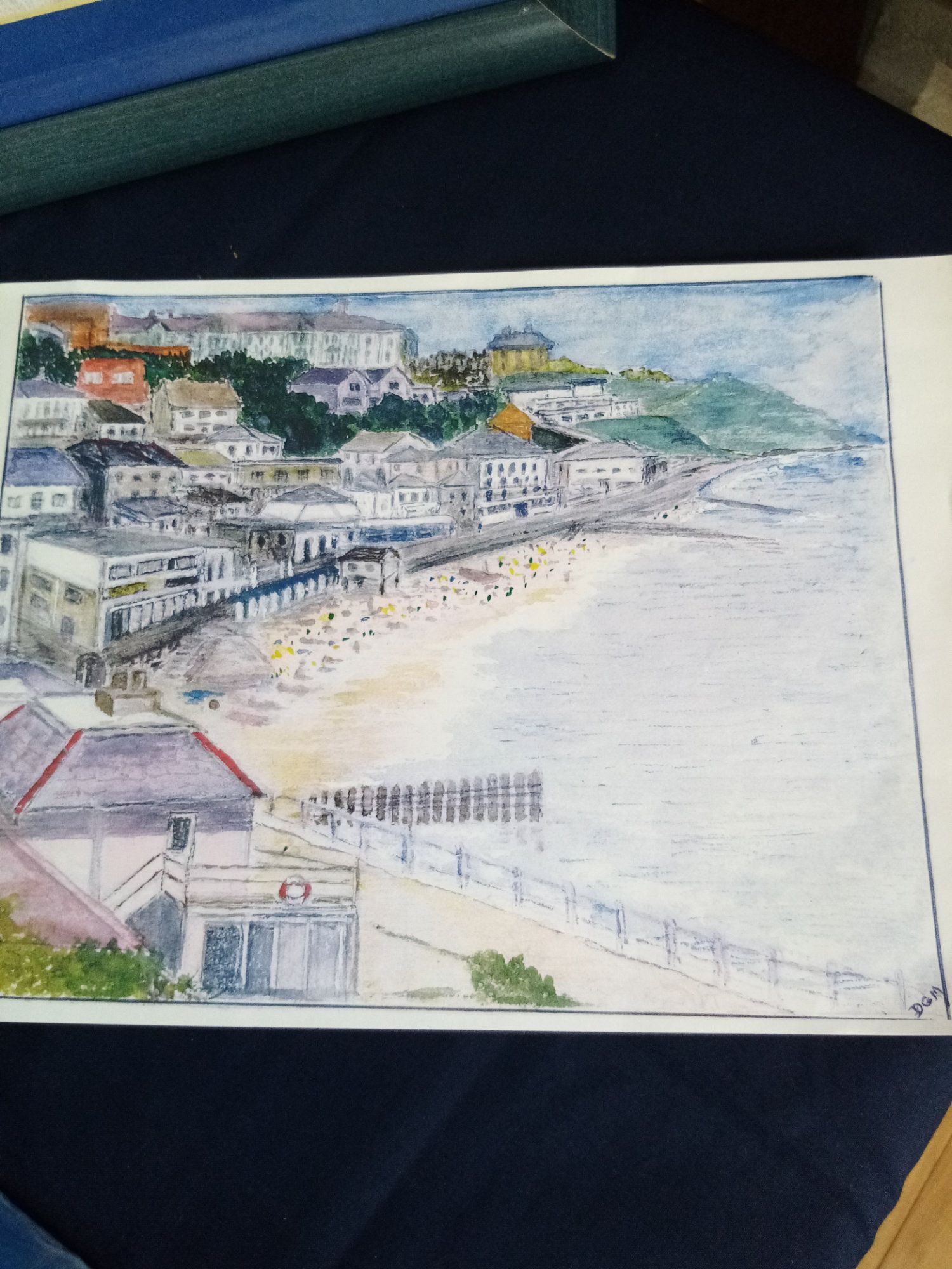 A painting of a beach with buildings and a pier