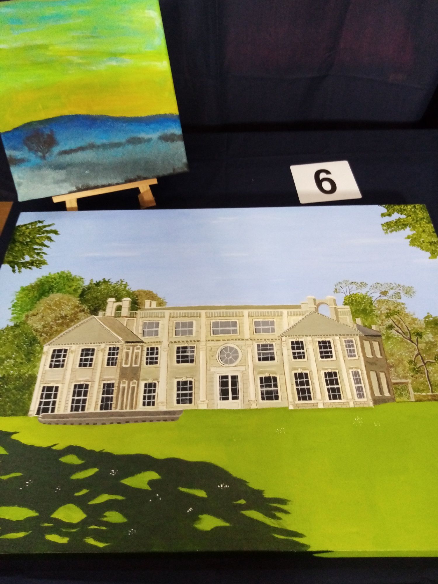 A painting of a house with the number 6 on it