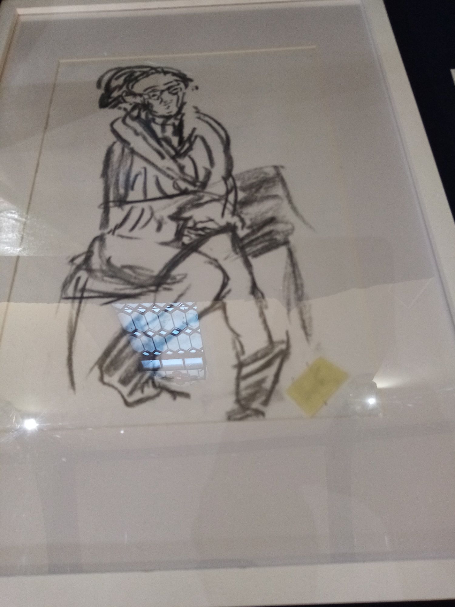 A black and white drawing of a man sitting on a chair