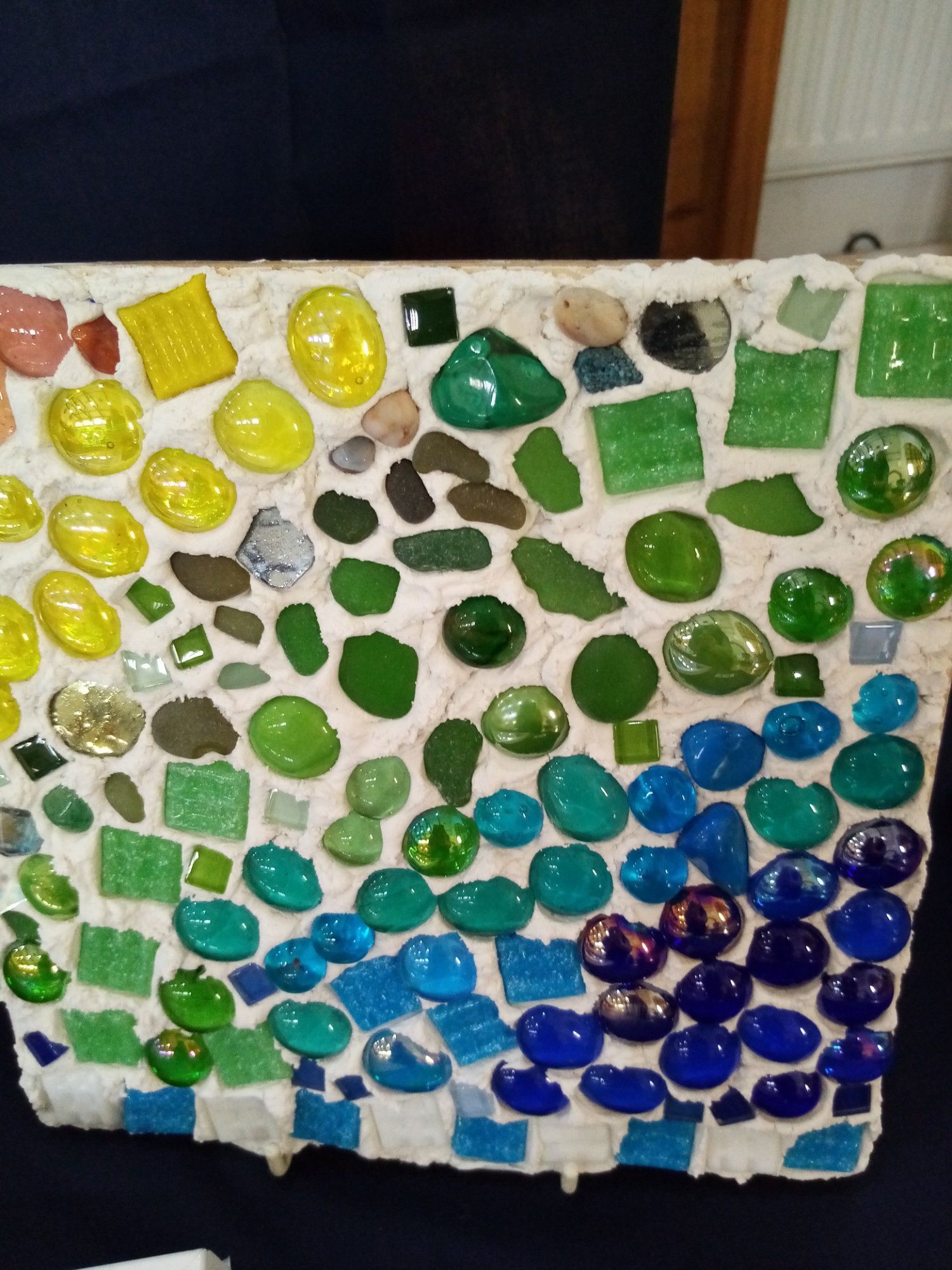 A rainbow of glass beads on a piece of paper