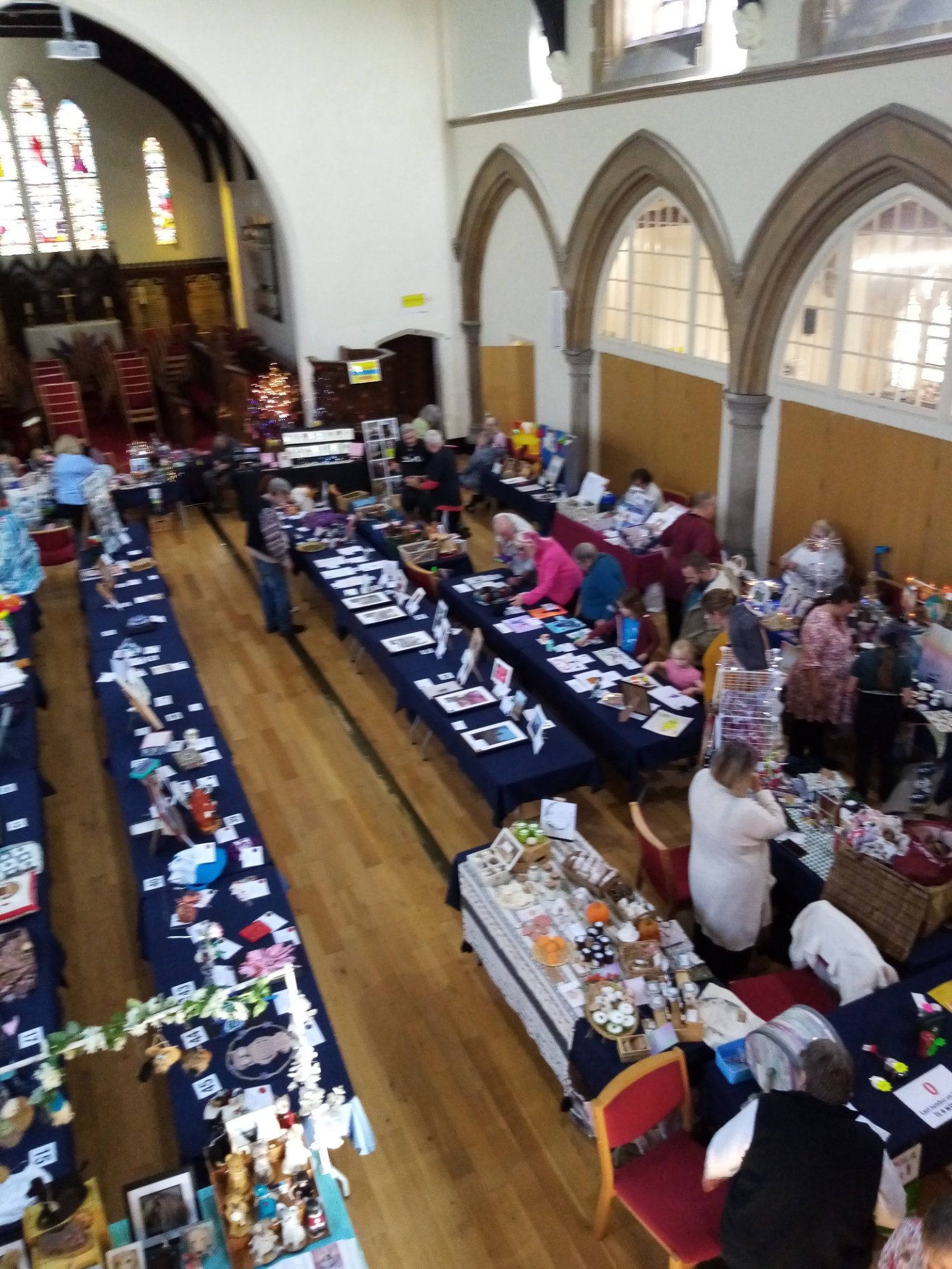 A group of people are sitting at tables in a church