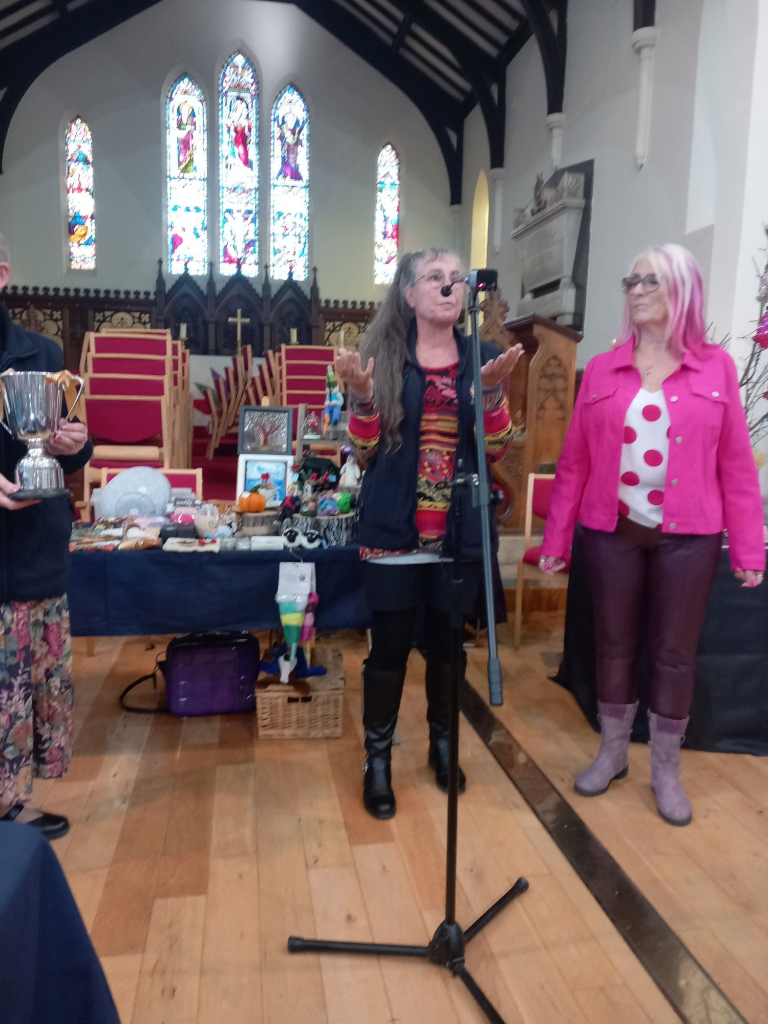 A woman singing into a microphone in a church