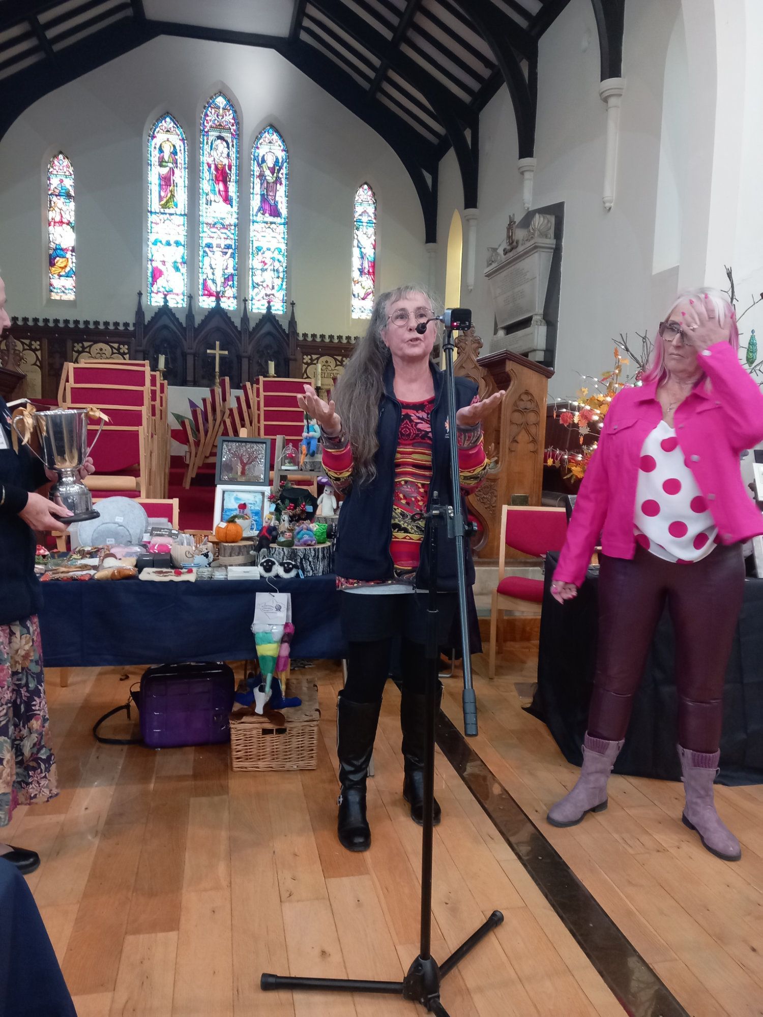 A woman singing into a microphone in a church