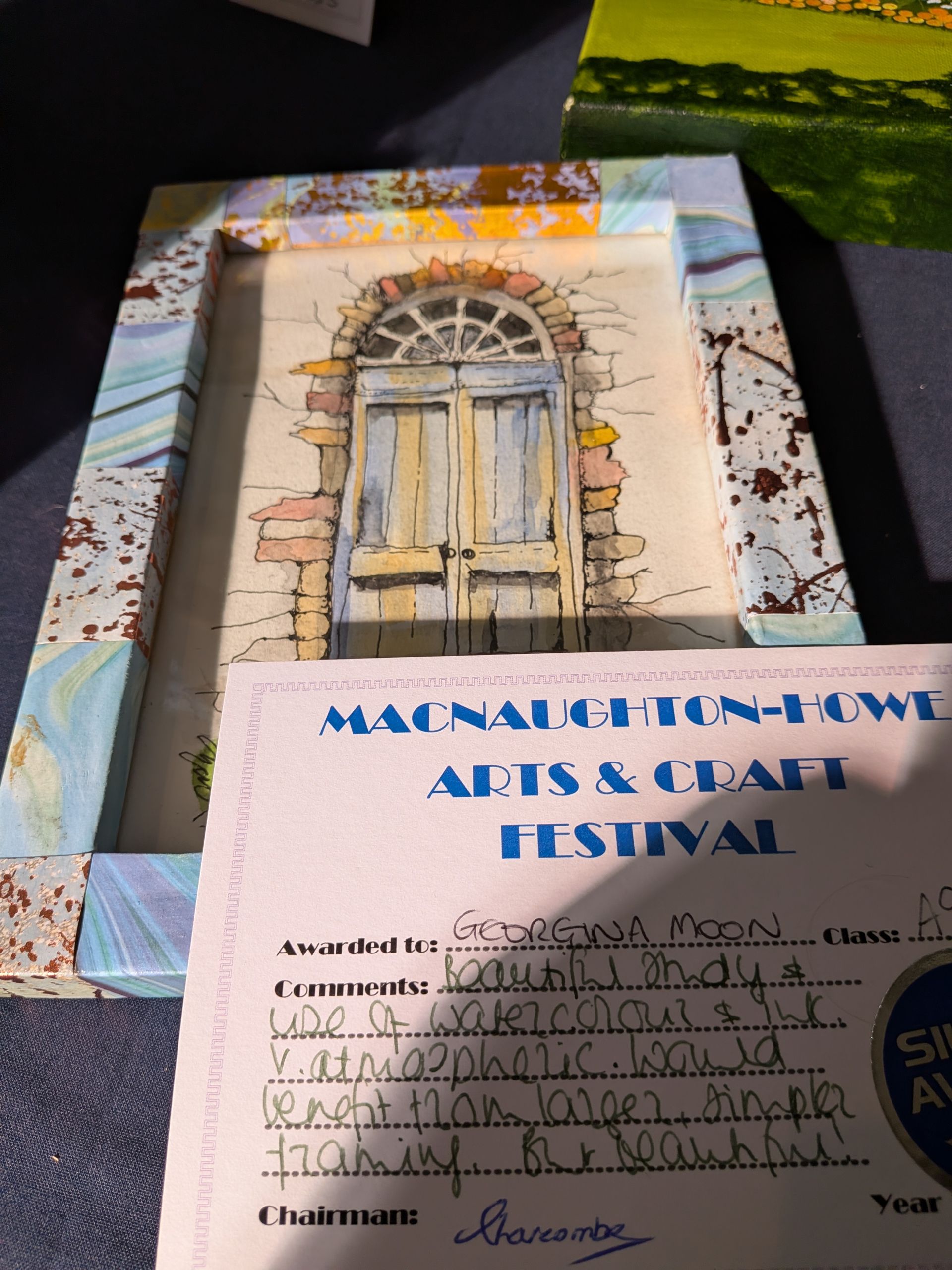 Artwork of a door in a frame, with a certificate from the 