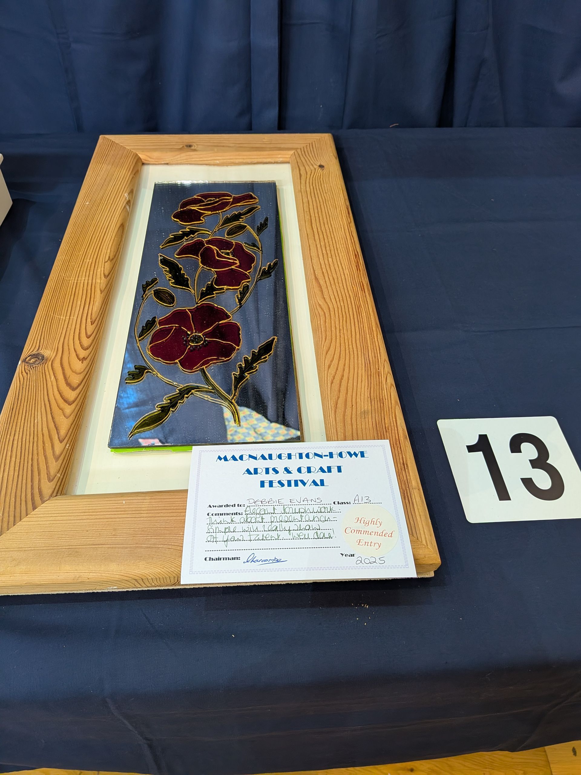 Stained glass floral art in a wooden frame; a table with a number 13.