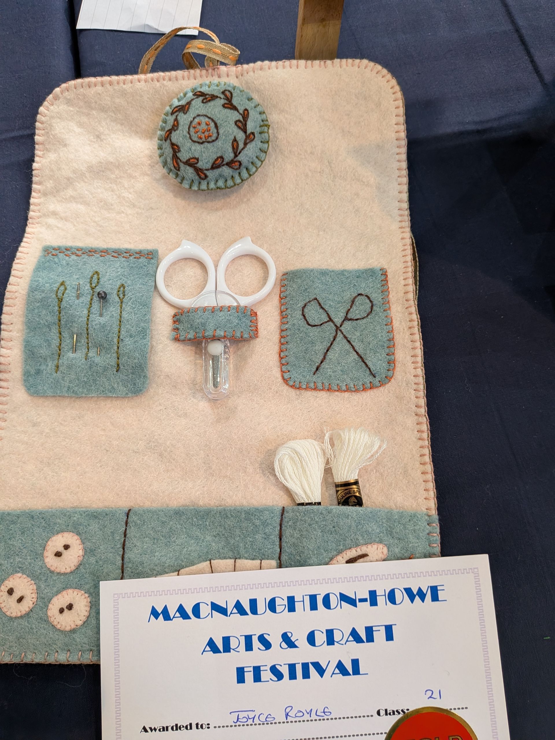 Craft kit made of felt, with scissors, embroidery, and a festival certificate.