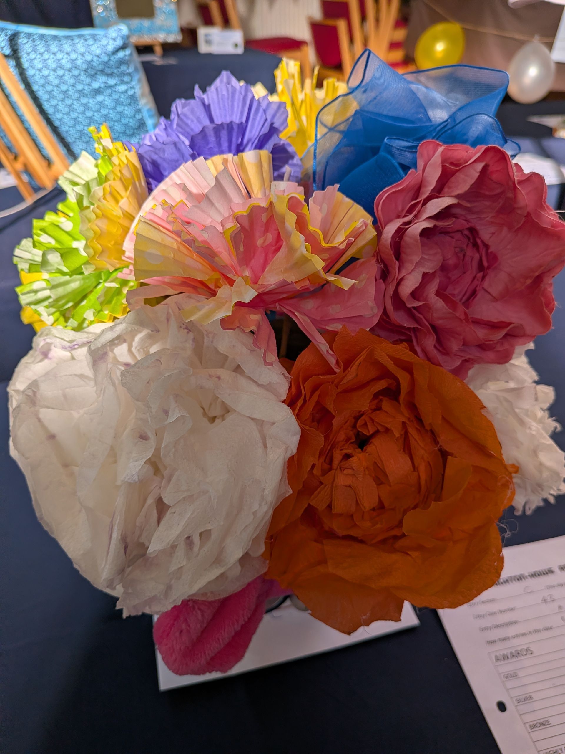 Colorful bouquet made from paper flowers, sitting on a table.
