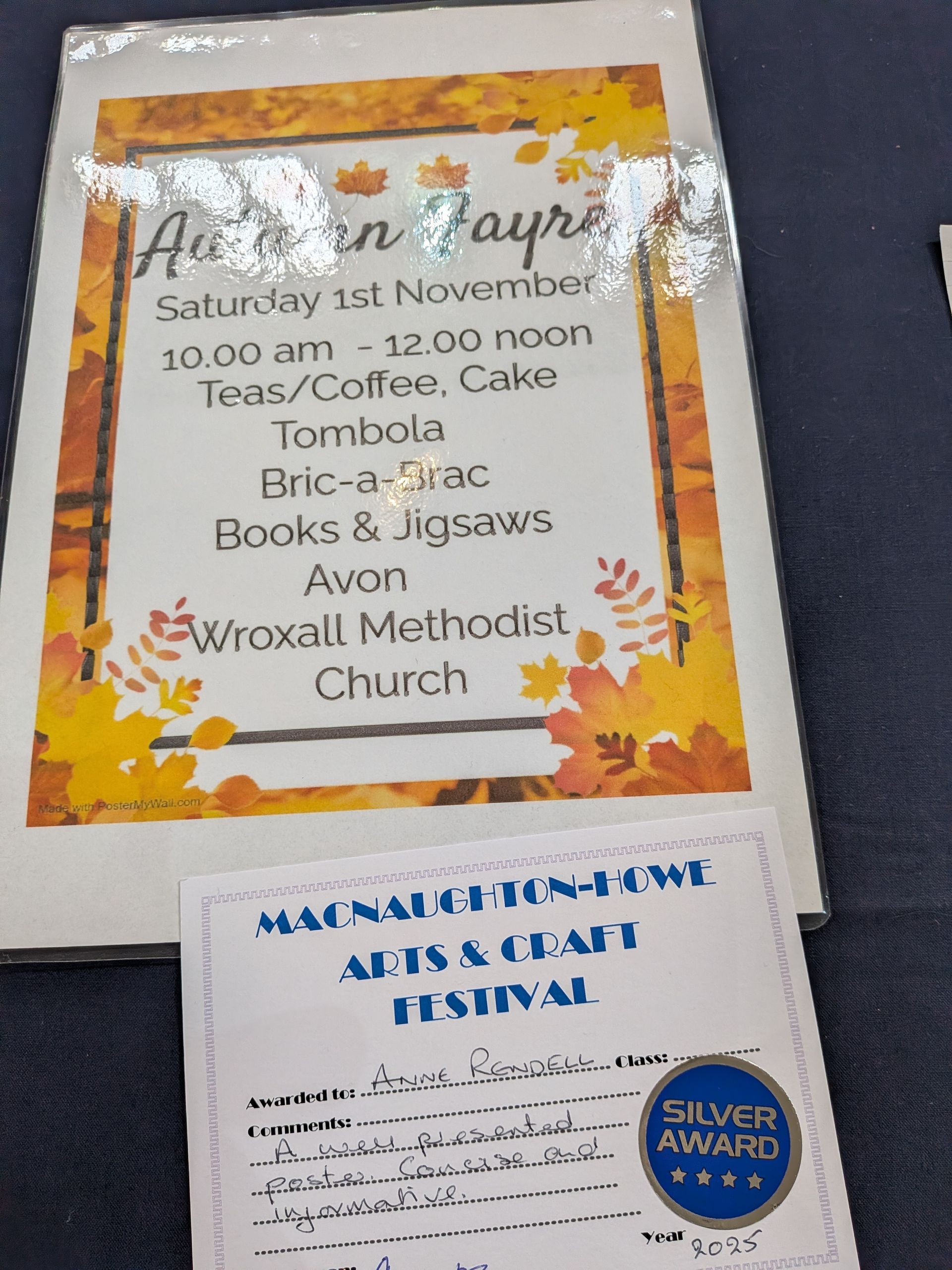 Autumn Fayre poster with event details and a small certificate labeled 