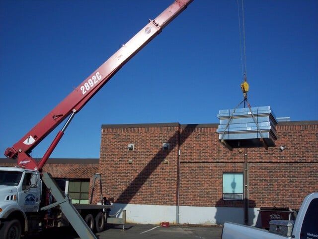 red lifting machine and sky - AC repairs in Trinidad, CO