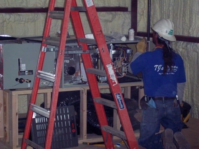 Repairman and red ladder- AC repairs in Trinidad, CO