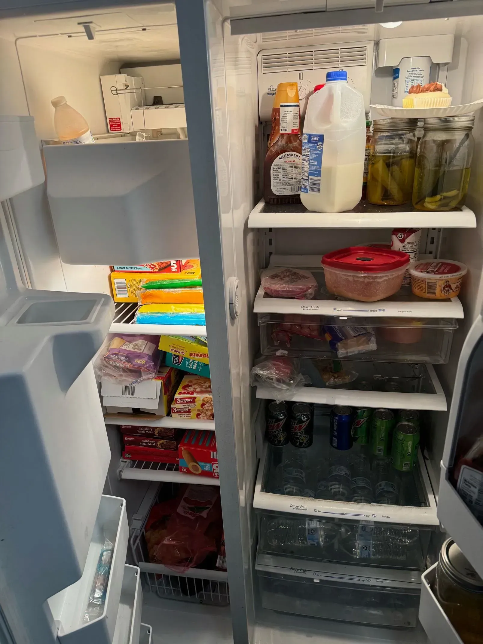 A refrigerator filled with lots of food and drinks.