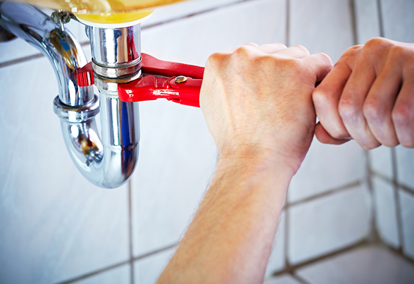 Plumber Fixing Kitchen Sink — Staten Island, NY — Capital Contracting, Plumbing & Heating Corp.