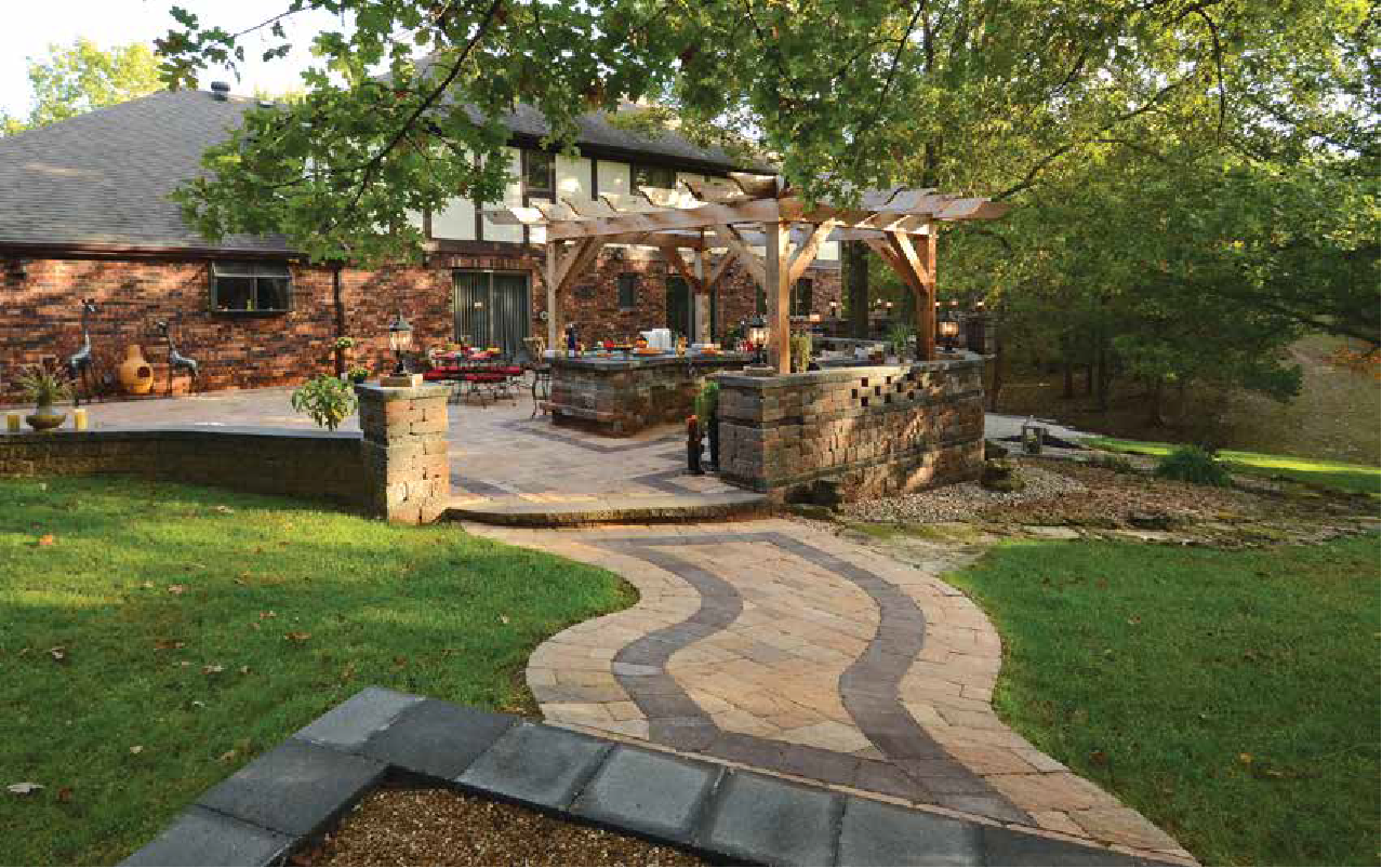 Patio Space by Stockman Stoneworks With a Pergola & Seating