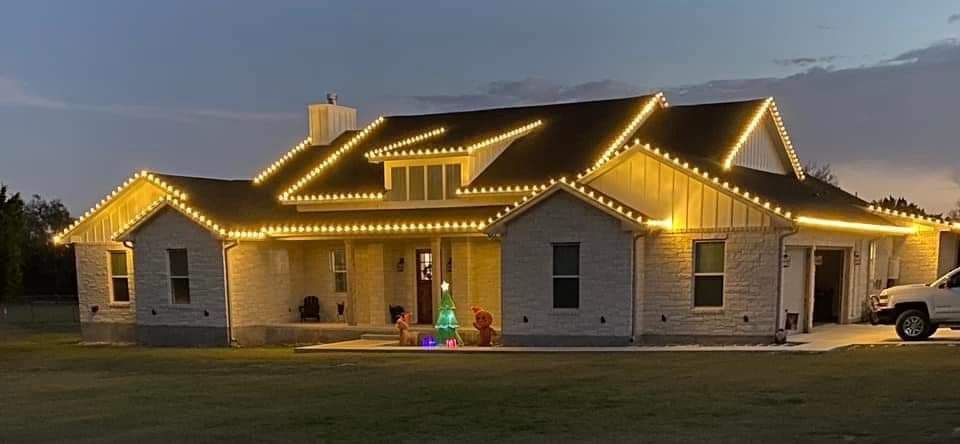 House decorated with yellow Christmas lights.
