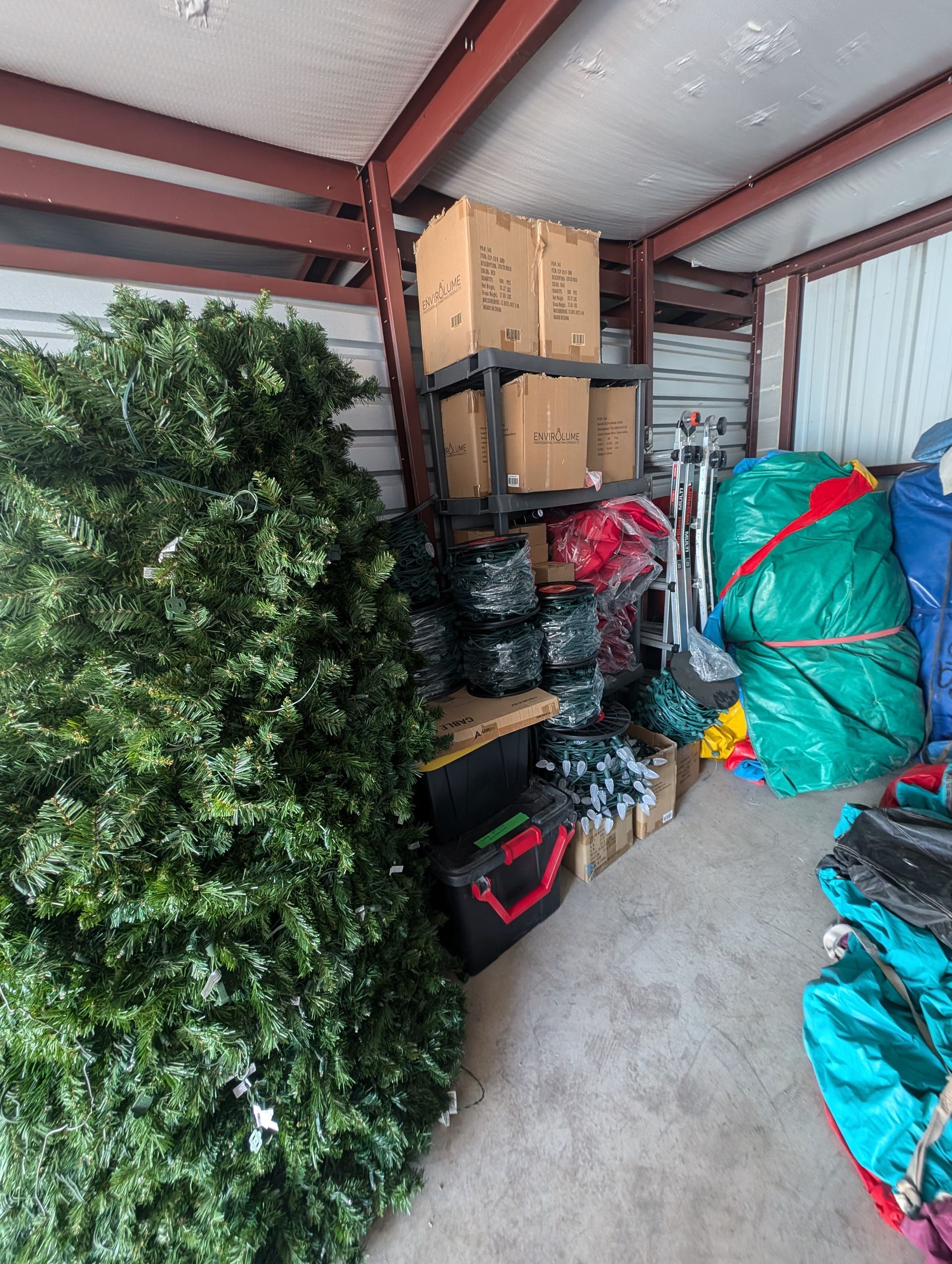 A storage unit filled with Christmas decorations, equipment, and boxes.