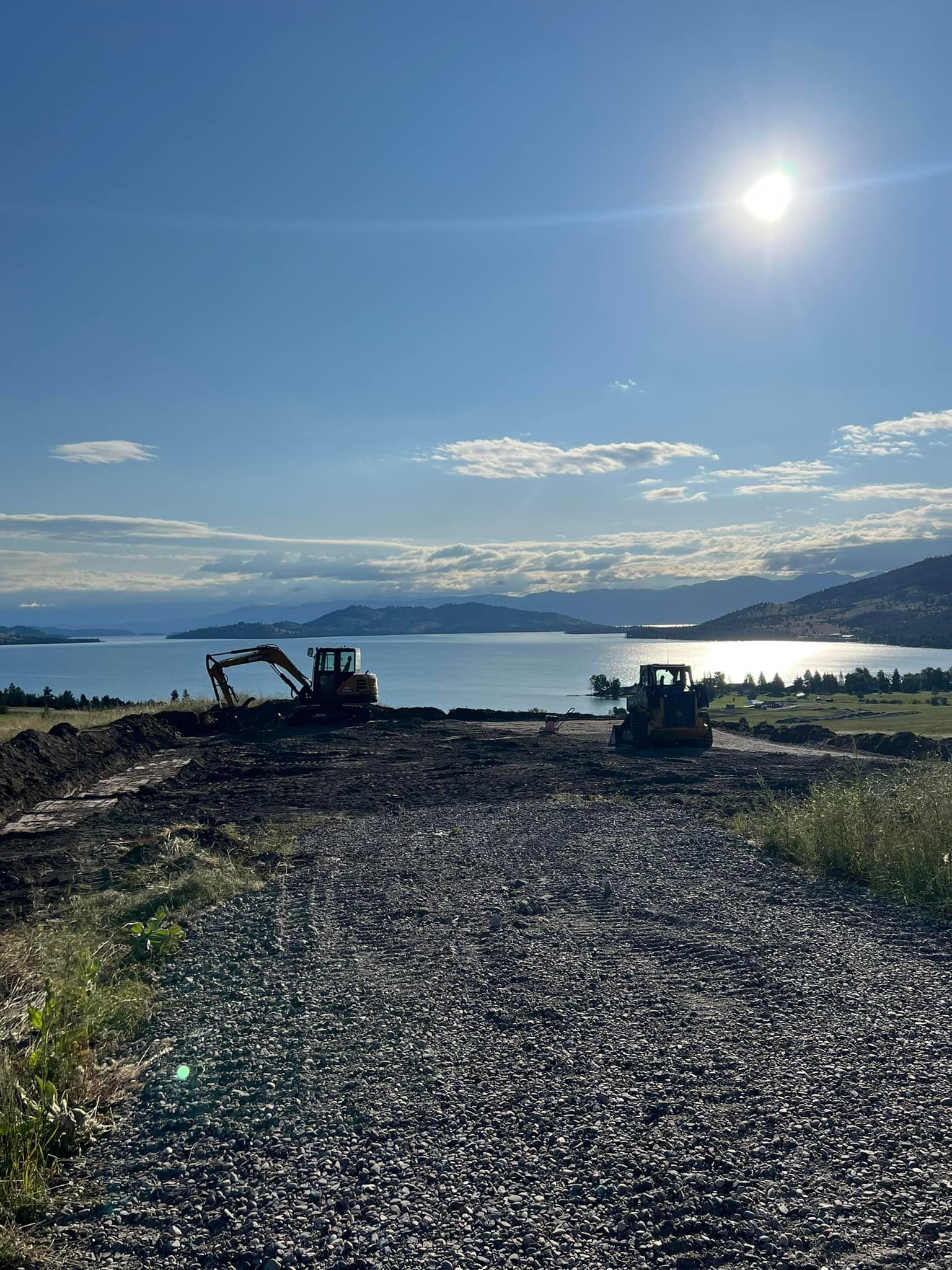 A construction site with a large body of water in the background.