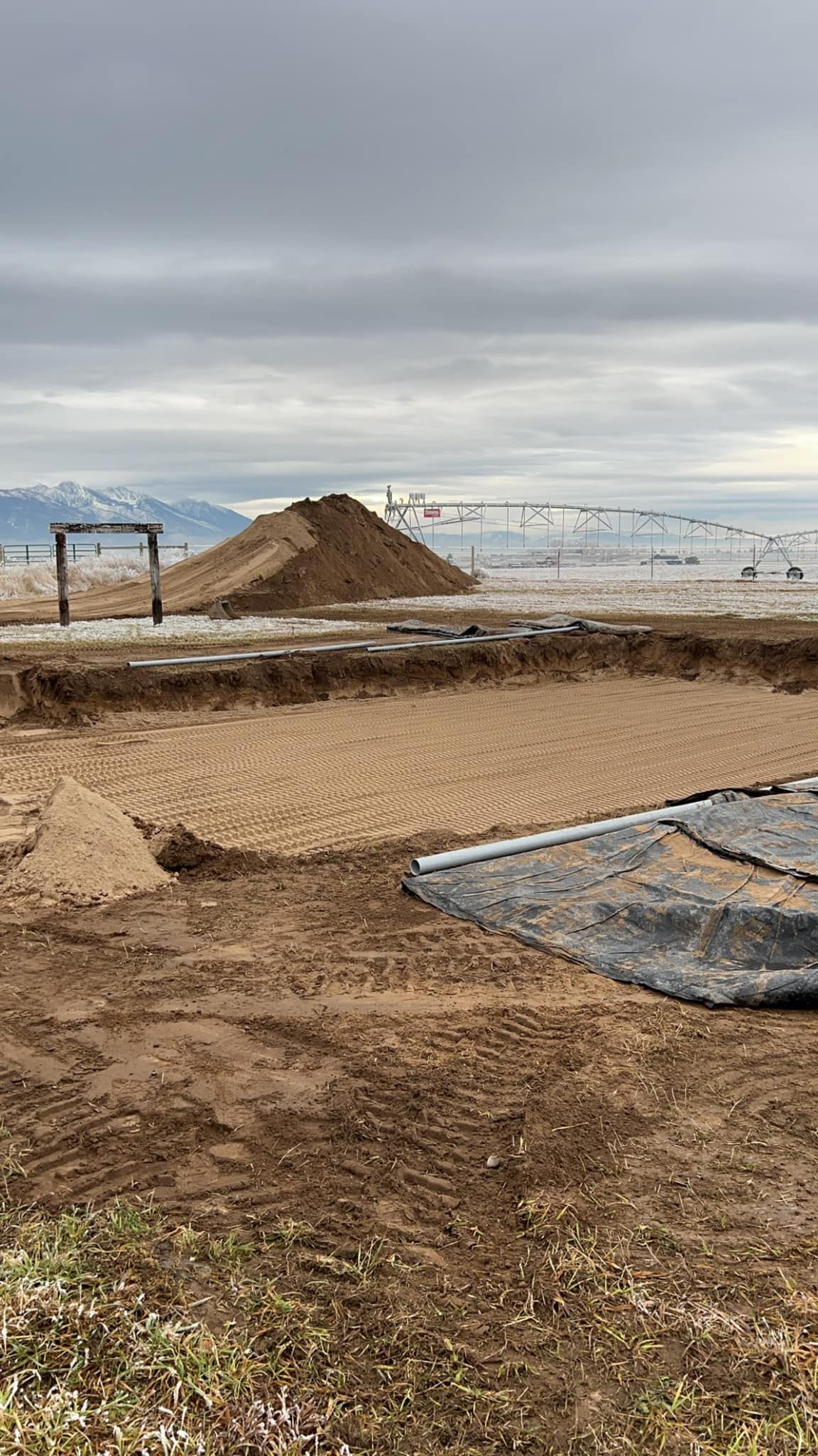 A large pile of dirt is sitting on top of a dirt field.