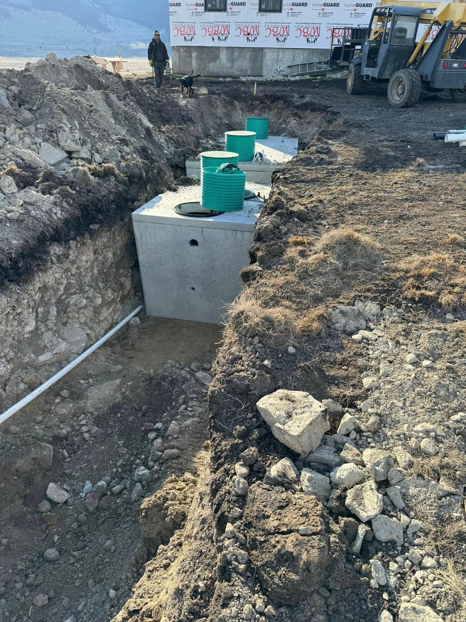 A large concrete block is sitting in the middle of a dirt field.
