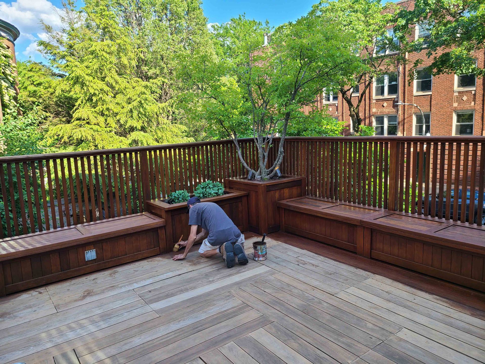 Man is Kneeling on a Wooden Deck — Chicago, IL — McMaster Painting