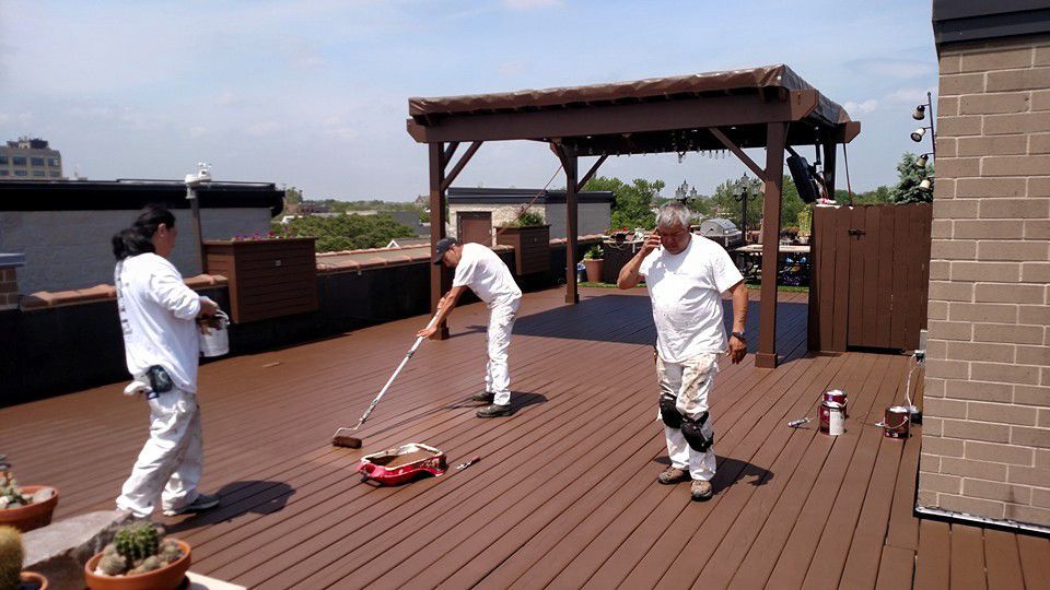 Group of People Are Painting a Deck on a Rooftop — Chicago, IL — McMaster Painting