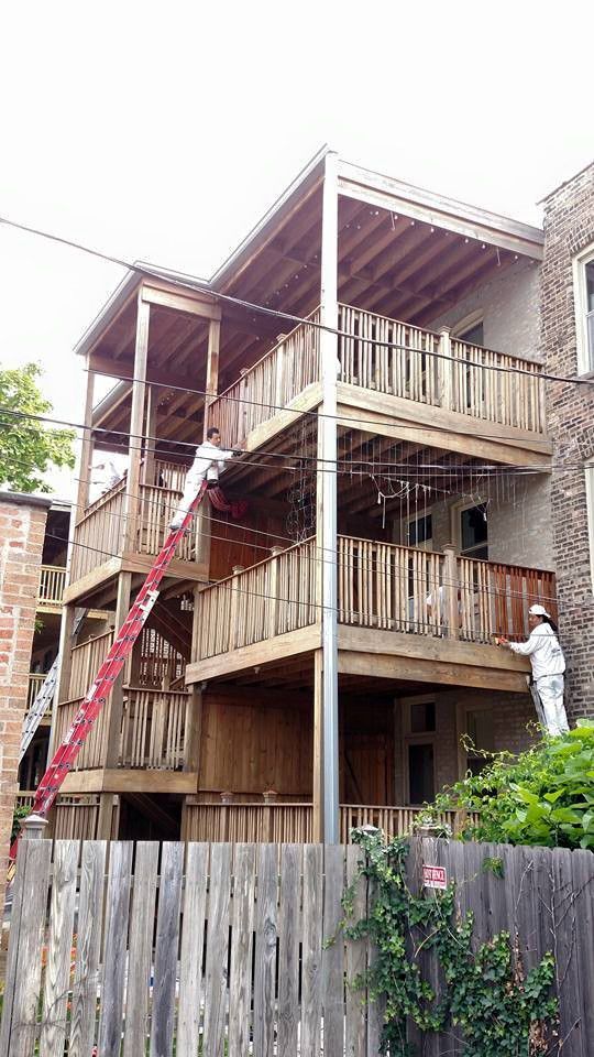 Man is Painting the Outside of a Building With a Ladder — Chicago, IL — McMaster Painting