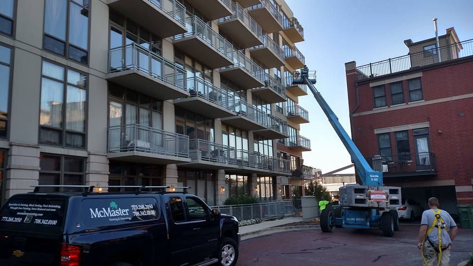 A Truck Is Parked In Front Of A Tall Building — Chicago, IL — McMaster Painting