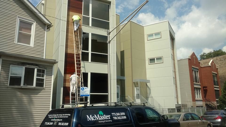 A McMaster Van Is Parked In Front Of A Building — Chicago, IL — McMaster Painting