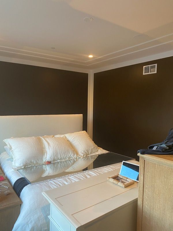 A bedroom with a bed , nightstand , and dresser.