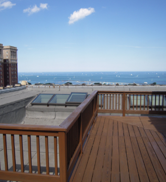 A Wooden Deck with A Railing Overlooking the Ocean — Chicago, IL — McMaster Painting