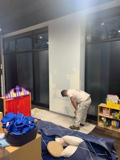 A Man Is Painting a Wall in A Room with Toys - Chicago, IL - McMaster Painting