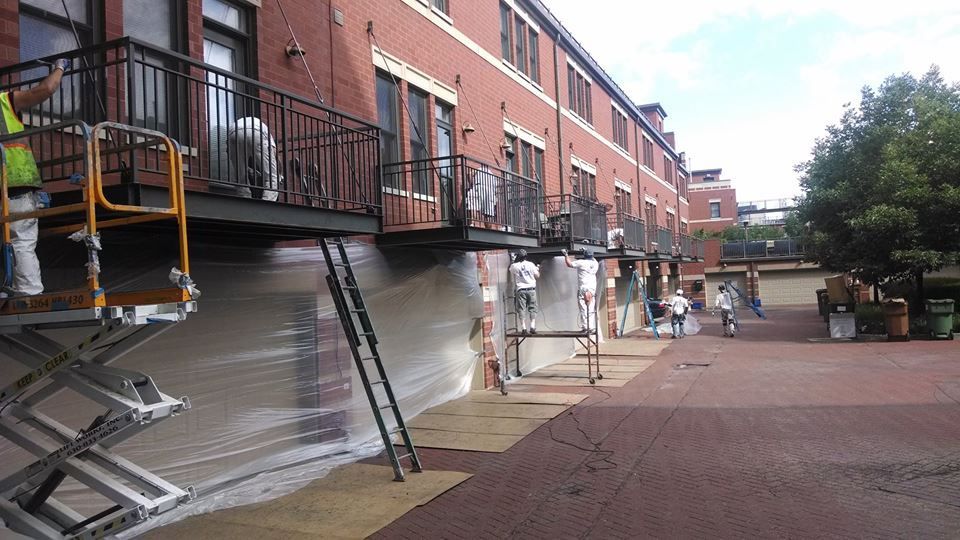 A Group of People Are Painting the Side of A Building — Chicago, IL — McMaster Painting