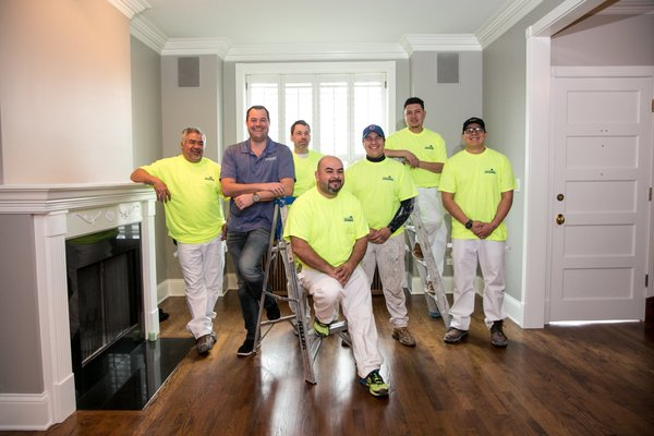 A Group of Men Are Posing for A Picture in A Living Room — Chicago, IL — McMaster Painting