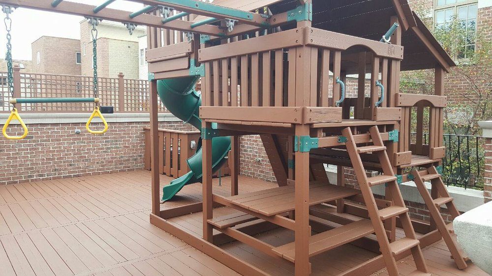 Wooden Playground With a Green Slide and Stairs — Chicago, IL — McMaster Painting