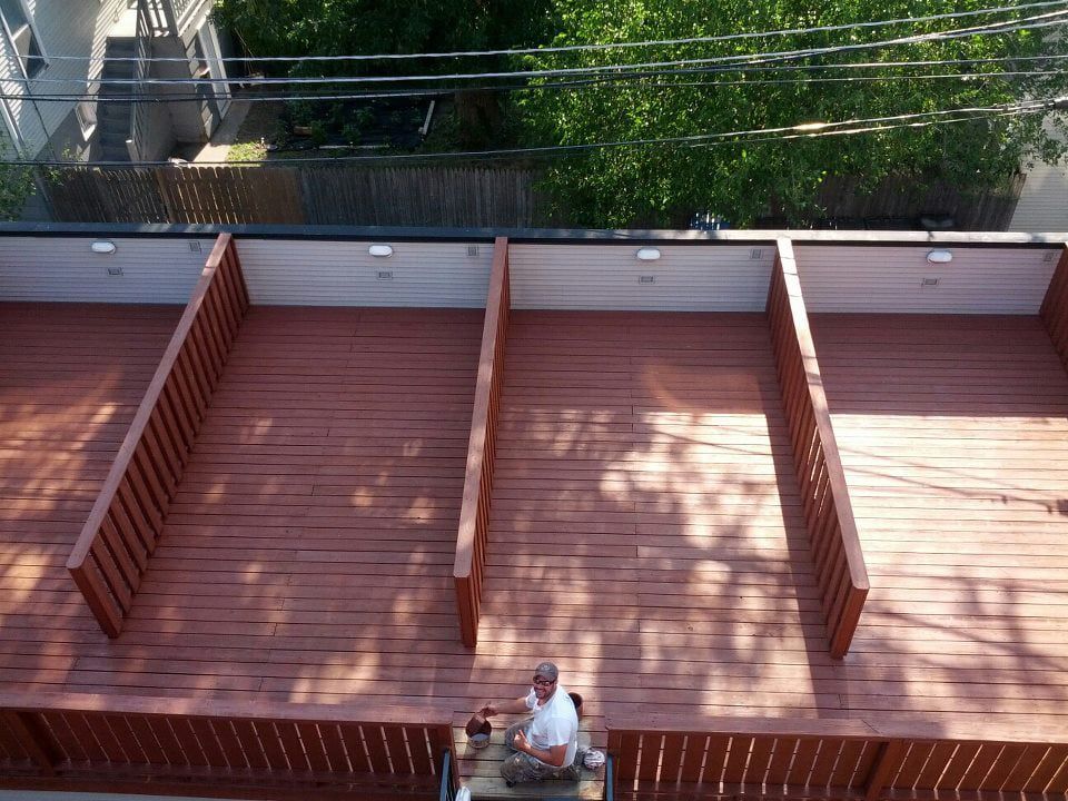 Man is Sitting on a Wooden Deck — Chicago, IL — McMaster Painting