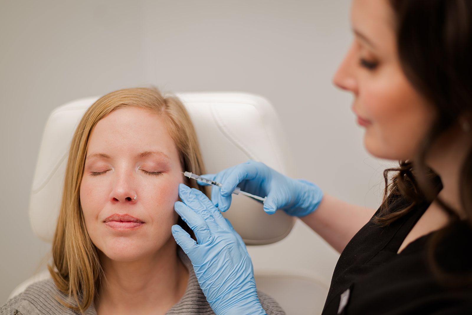 Nurse injector treating patient with injectables - botox