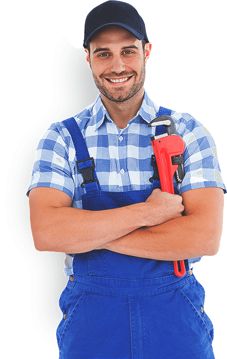 A man in overalls is holding a wrench and smiling.