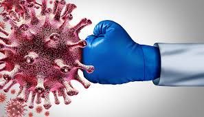 Blue-gloved fist punching a large red coronavirus. White coat sleeve. Fighting virus concept.