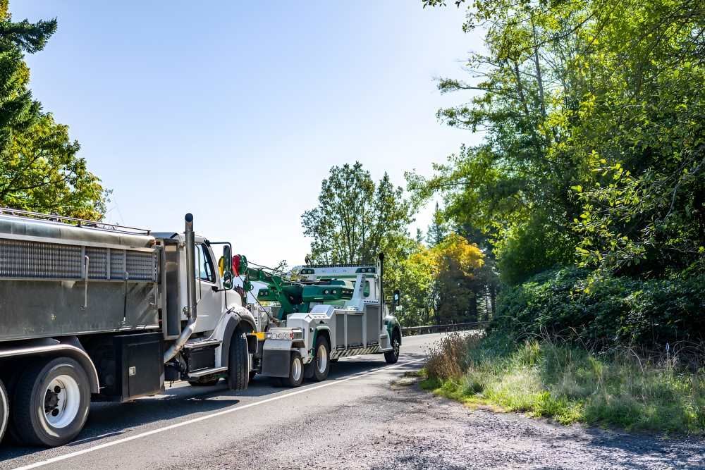 Two Dump Trucks Are Towed On The Side Of The Road — Big Tim's Towing in Sandgate, NSW