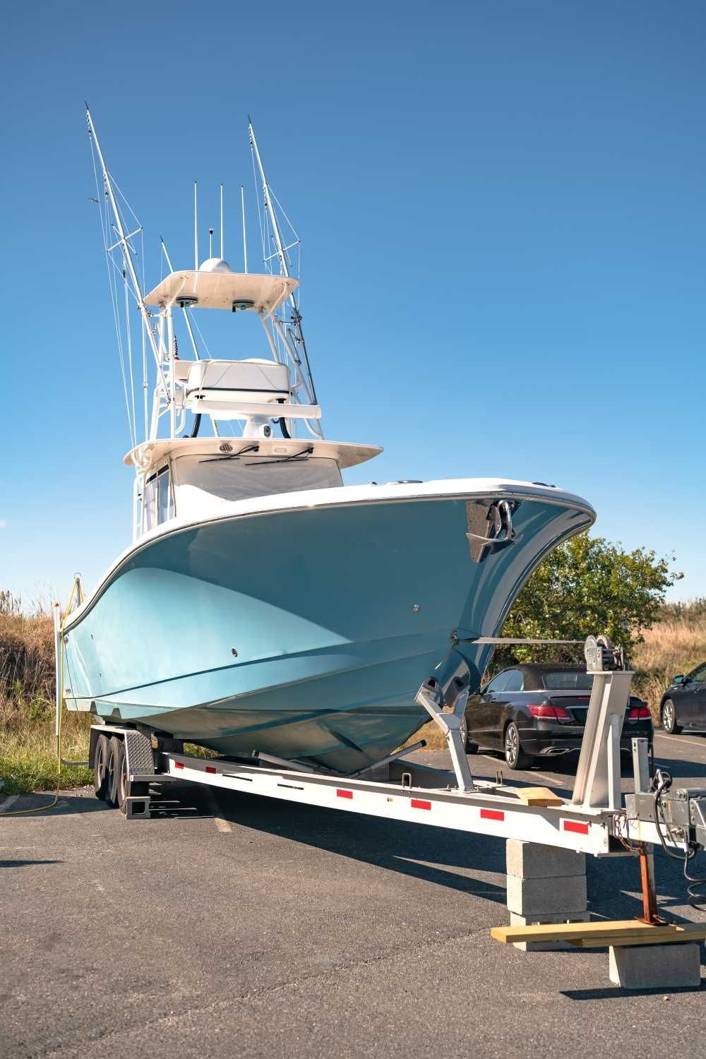 A Boat Is Sitting On A Trailer In A Parking Lot — Big Tim's Towing in Boolaroo, NSW