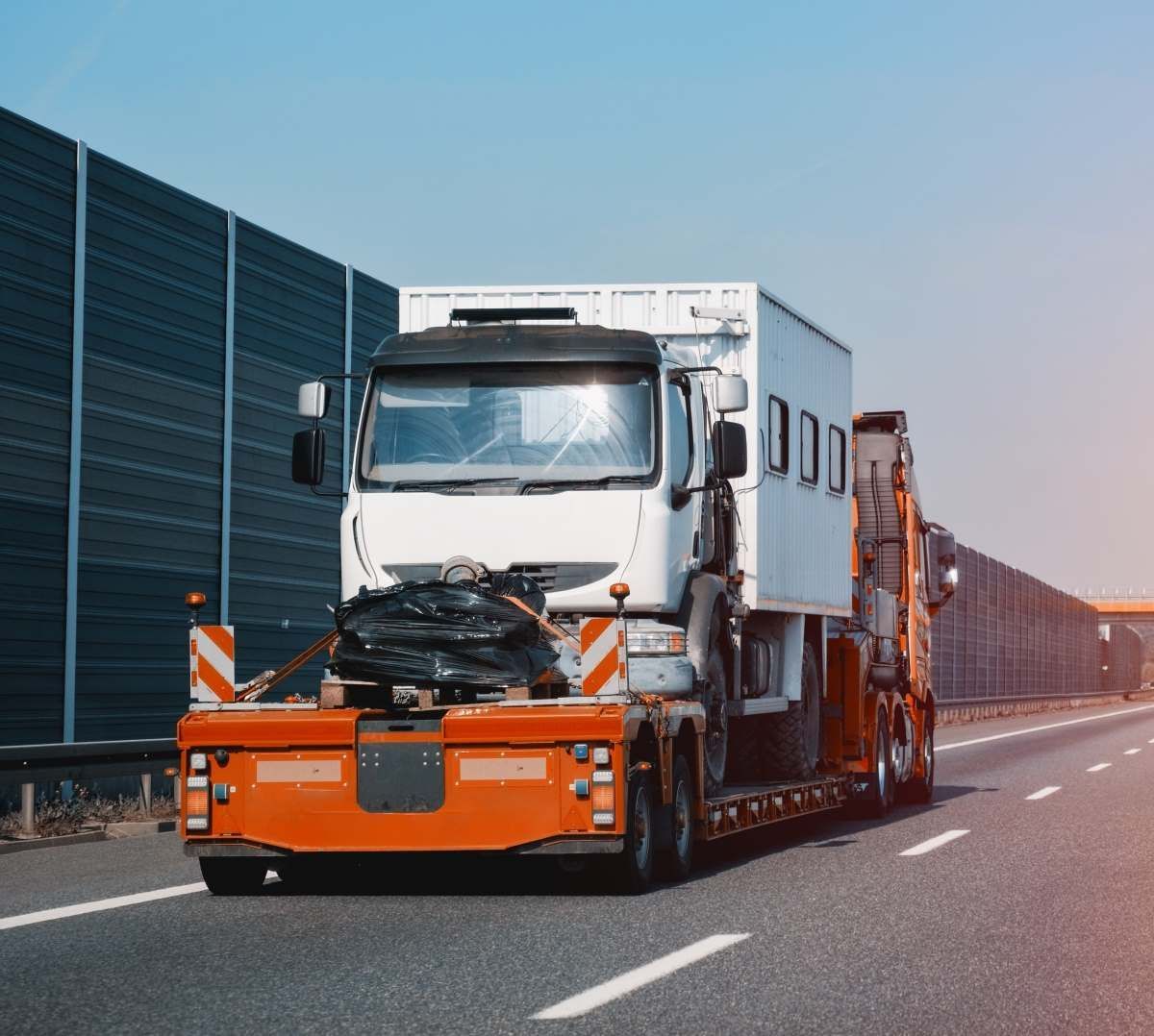 A Trailer Is Being Pulled By A Truck On The Highway — Big Tim's Towing in Toronto, NSW
