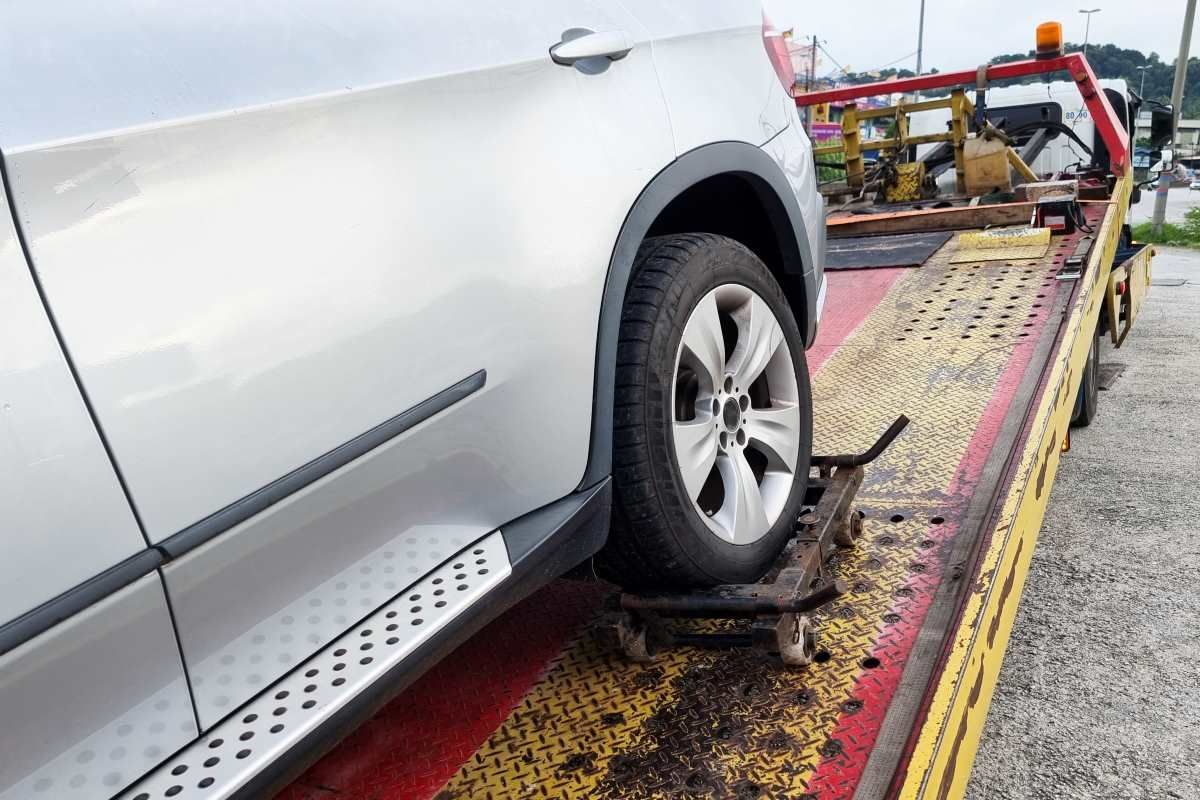 A Silver Car Is Sitting On Top Of A Tow Truck — Big Tim's Towing in Rankin Park, NSW