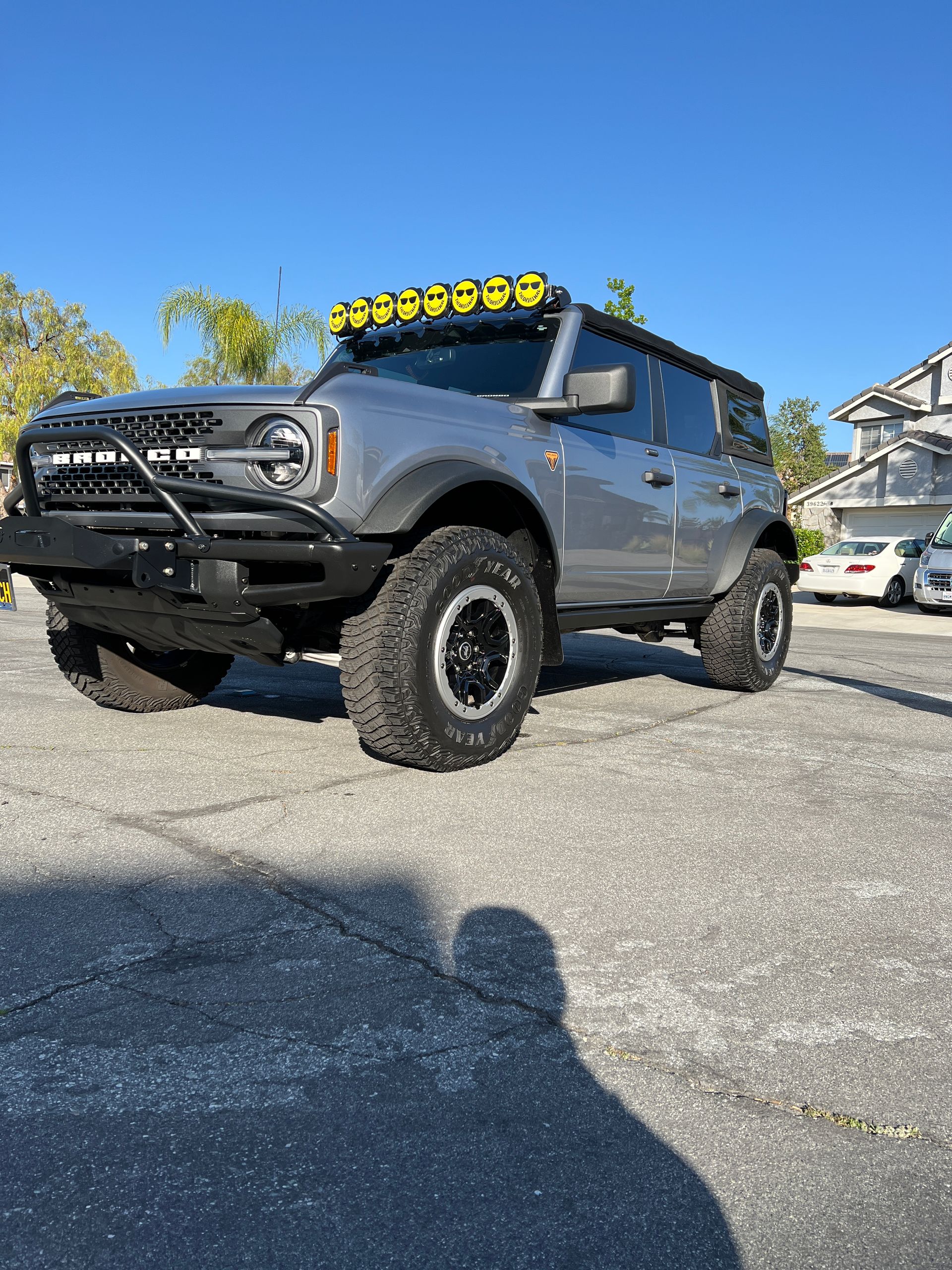 A ford bronco is parked in a parking lot.