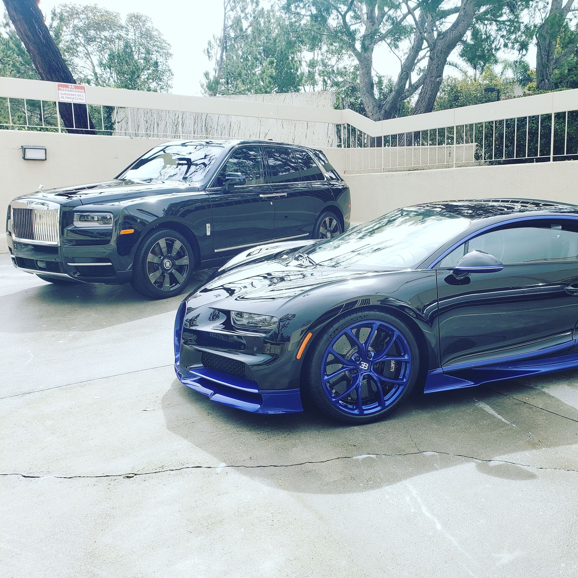 Two cars are parked next to each other in a parking lot.
