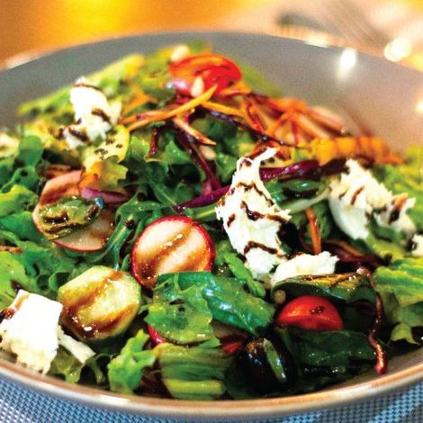 A close up of a salad in a bowl on a table