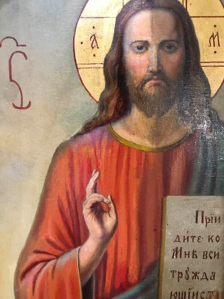 A close up of a painting of jesus holding a book