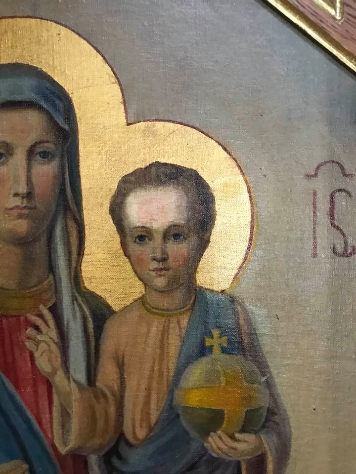 A painting of a woman holding a baby in her arms