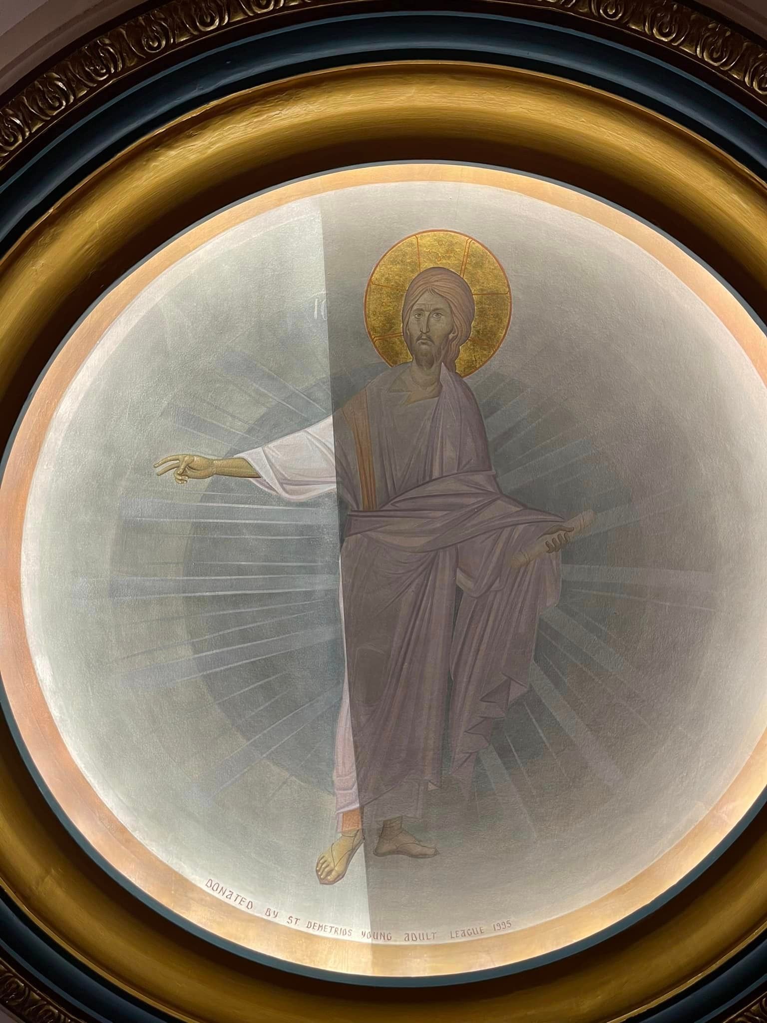 A painting of jesus in a gold frame